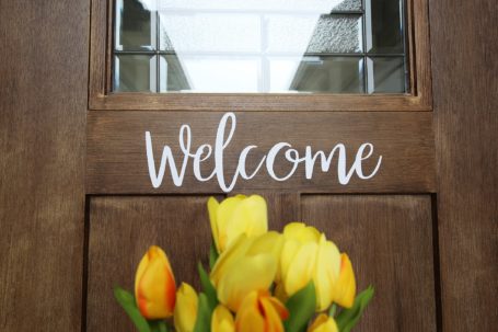 An image of a Welcome sign on the door